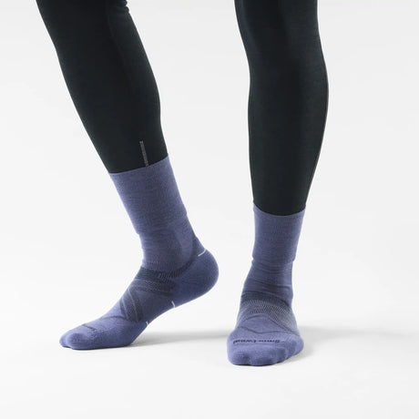 Smartwool Glow women's merino wool running crew sock in dusk blue, worn with running tights