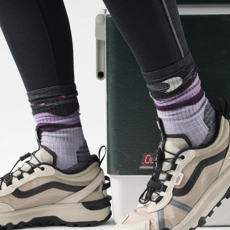 Smartwool Lunar Trek women's merino wool hiking crew sock in purple eclipse with loon and moon motif, worn with sneakers